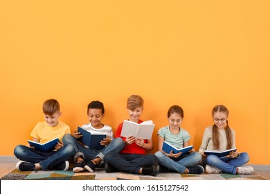 Cute little children reading books on color background - Shutterstock ID 1615127542