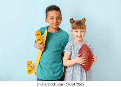 Cute little children with skateboard and rugby ball on color background - Powered by Shutterstock