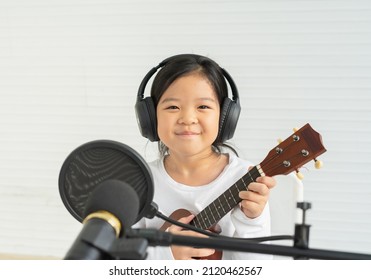 Cute Little Children Smile, Happy, Listen Music, Show Playing Guitar, Look At Camera. Asian Children Study And Learn Musical And Singing In Education Classroom At Small School