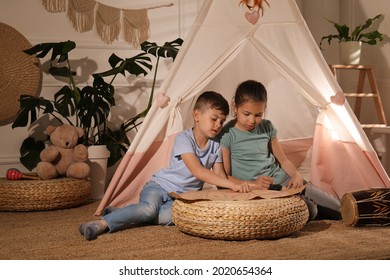 Cute Little Children With Treasure Map Near Toy Wigwam At Home