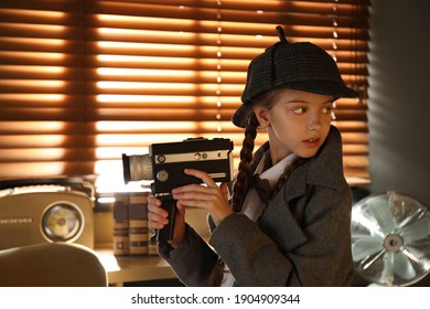 Cute Little Detective With Vintage Video Camera In Office