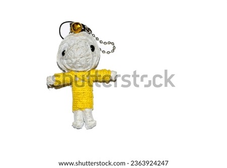 Cute little doll isolated on white background. Charm keychain for a children bag. Kids sewing crafts idea