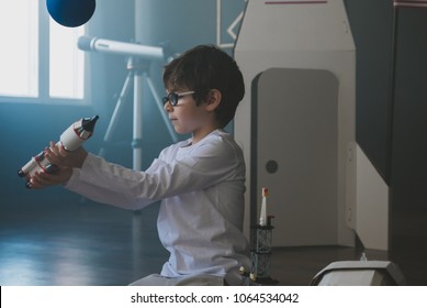 Cute Little Dreamer Boy Playing With Toy Rocket, Dreaming Of Becoming An Astronaut Or Scientist