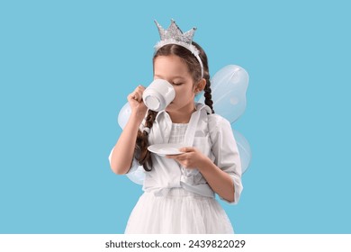 Cute little fairy drinking tea on blue background - Powered by Shutterstock