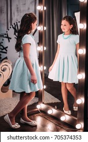 Cute Little Fashionista. Happy Child Girl Looking At Mirror.