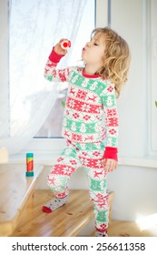 Cute Little Girl Blowing Bubbles At Home