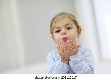 Cute Little Girl Blowing Kisses Away