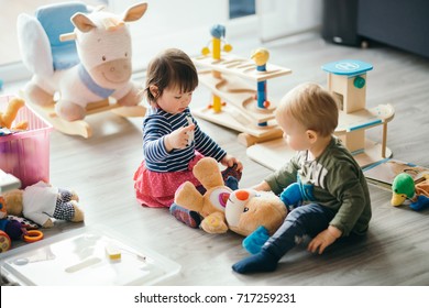 cute little girl and boy playing with toys by the home - Powered by Shutterstock