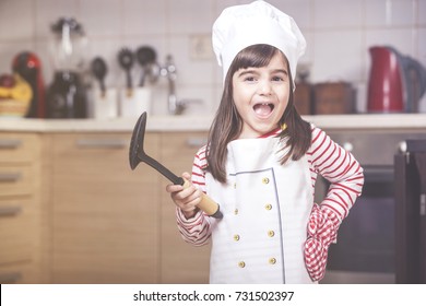 Cute little girl chef in the kitchen