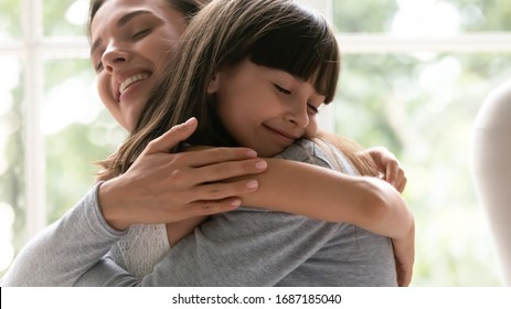 Cute little girl child embrace happy young mother show gratitude and love, caring happy smiling mom hug small preschooler daughter make peace reconcile after fight, family bonding, unity concept