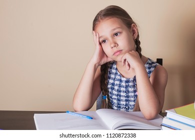Cute little girl doing homework, reading a book, coloring pages, writing and painting. Children paint. Kids draw. Preschoolers learn to write and read. Creative toddler .