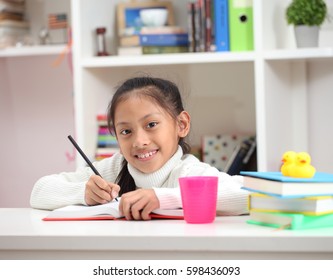 Cute Little Girl Doing Homework Reading A Book Coloring Pages Writing And Painting. Children Paint. Kids Draw.Creative Toddler.Asian Girl Write Ane Read Homework In The Room.