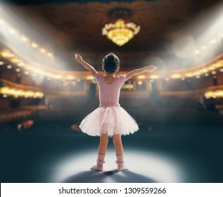 Cute Little Girl Dreaming Of Becoming A Ballerina. Child Girl In A Pink Tutu Dancing On The Stage. Baby Girl Is Studying Ballet.