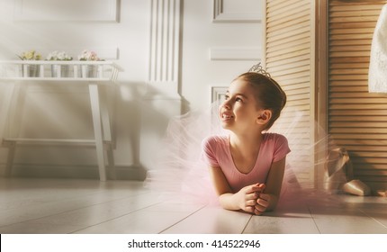 Cute Little Girl Dreams Of Becoming A Ballerina. Child Girl In A Pink Tutu Dancing In A Room. Baby Girl Is Studying Ballet.