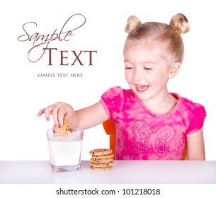 Cute Little Girl Dunking Cookie In Milk Isolated On White Background