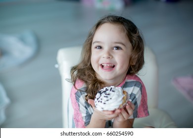Cute little girl eating a cake