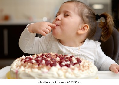  cute little girl eating cake