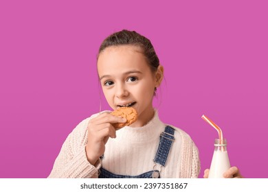 Cute little girl eating cookie with milk on purple background - Powered by Shutterstock