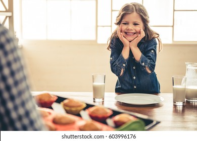 Cute little girl is feeling happy when her mom bringing muffins - Powered by Shutterstock