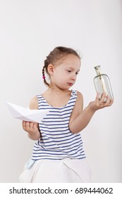 Cute Little Girl Find Secret Message In Glass Bottle. Isolated On White Bacgkround