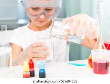 cute little girl with flasks for chemistry close-up