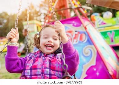 Cute Little Girl At Fun Fair, Chain Swing Ride