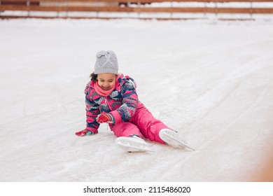 Cute Little Girl, Getting Up From A Fall, While Skating.