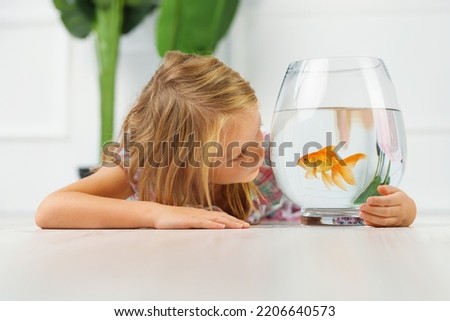  cute little girl and goldfish 