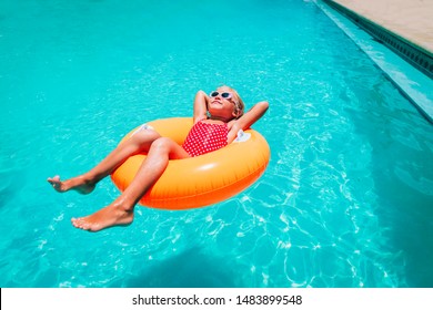 Cute Little Girl Have Fun At The Pool, Child Relax In Floatie
