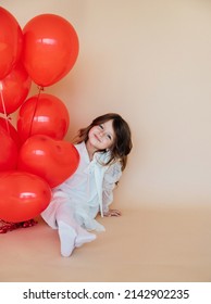 Cute Little Girl With Heart Shaped Balloons On Valentine's Day. Family, Love. Gifts For The Holiday. Happy Birthday Baby.