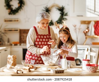 Cute little girl helping senior grandmother to make dough for traditional Christmas cookies, cooking together in cozy kitchen during winter holidays, grandma preparing holiday food with granddaughter - Powered by Shutterstock