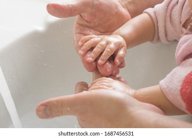 Cute Little Girl And Her Father Are Washing Hands Under Running Water. Stay Clean. Stay Safe. Wash Your Hands. Corona Virus Protection.