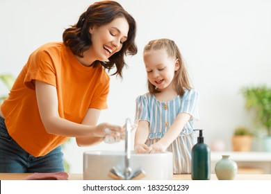 A cute little girl and her mother are washing their hands. Protection against infections and viruses.      - Powered by Shutterstock