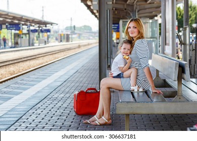 Cute Little Girl And Her Mother On A Railway Station. Kid And Woman Waiting For Train And Happy About A Journey. People, Travel, Family, Lifestyle Concept