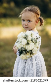 Cute Little Girl Holding Bouquet Of Flowers