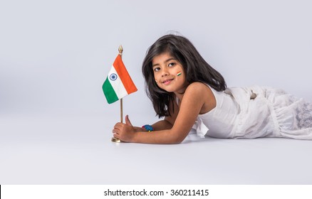Cute little girl with Indian National Tricolour Flag, Isolated over white background. Suitable for Independence Day or Republic Day concept