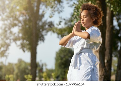 Cute little girl in kimono meditating on the street - Powered by Shutterstock