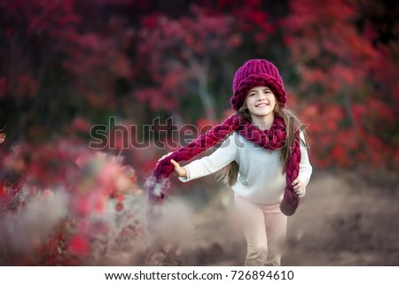 Similar – Herbstportrait eines lächelnden Kindmädchens mit Blumenstrauß aus Blättern