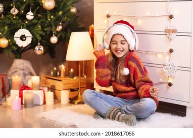 Cute Little Girl Listening To Christmas Music At Home