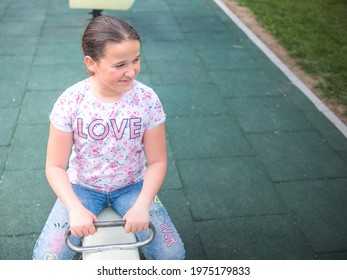 Cute Little Girl With Long Hair On See Saw