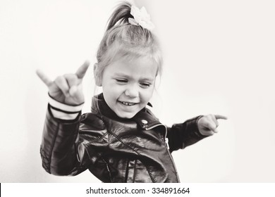 cute little girl making a rock-n-roll sign