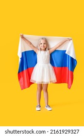 Cute Little Girl With National Flag Of Russia On Color Background