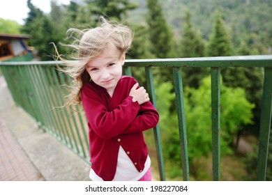 Cute little girl on a very windy day outdoors