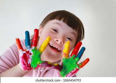 Cute little girl with painted hands - Shutterstock ID 1065454793