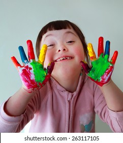 Cute little girl with painted hands. Isolated on grey background. - Shutterstock ID 263117105