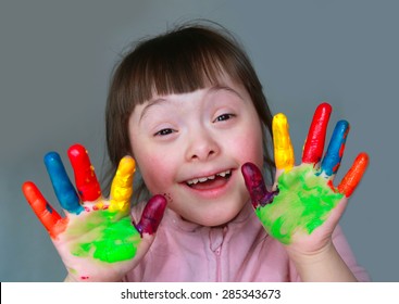 Cute little girl with painted hands. Isolated on grey background. - Shutterstock ID 285343673
