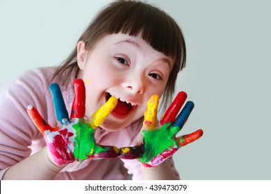 Cute little girl with painted hands. Isolated on grey background. - Shutterstock ID 439473079
