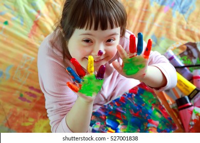 Cute little girl with painted hands - Shutterstock ID 527001838