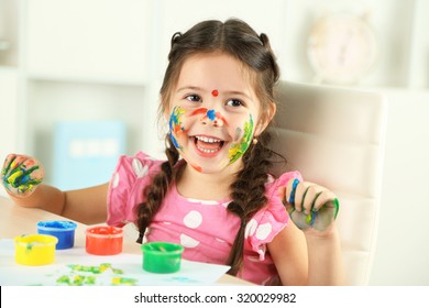 Cute Little Girl Painting Picture On Home Interior Background