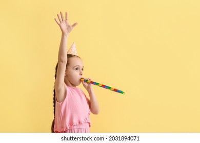 Cute Little Girl In Party Hat And With Noise Maker On Color Background